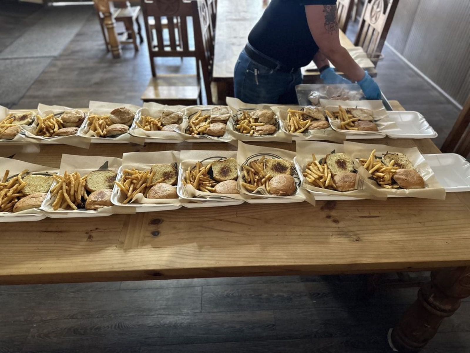 A group order of boxed burgers and fries, ready for delivery