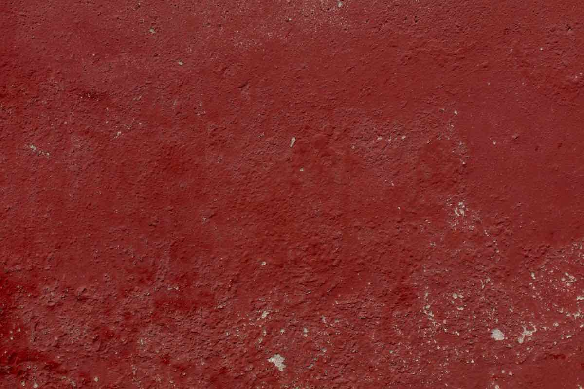 Weathered dark red painted wall texture